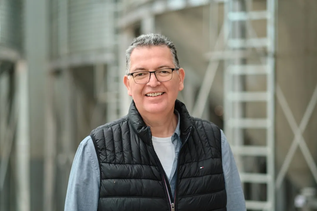 A team member in front of the seed silos